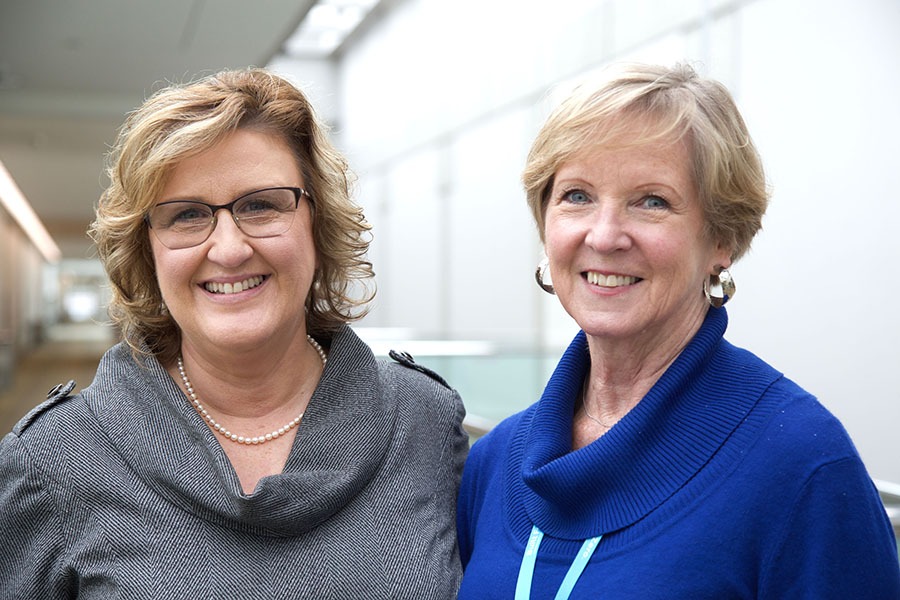 Two women in professional attire from the Gulfport Coast community