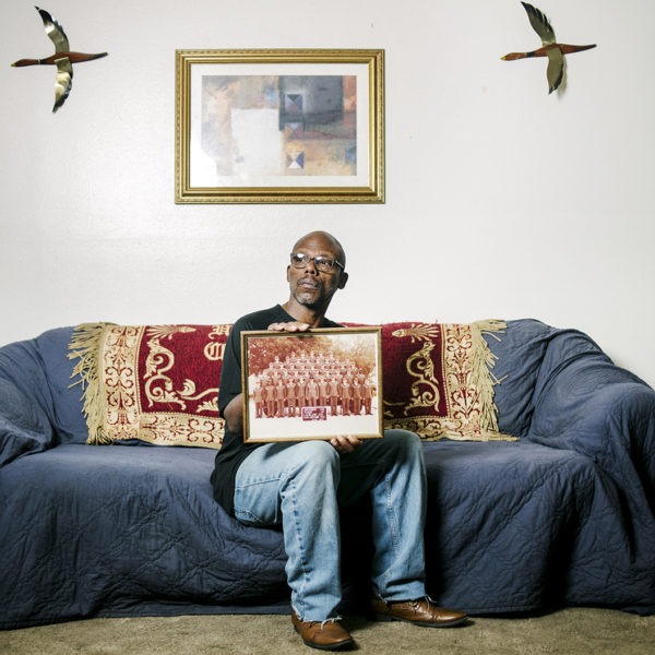 Man sitting on couch holding photo