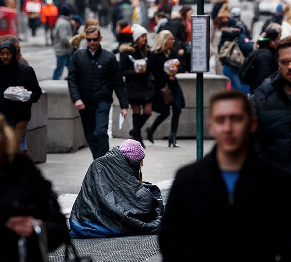 People on busy street around person experiencing homelessness
