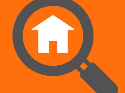 Icon of magnifying glass looking at house