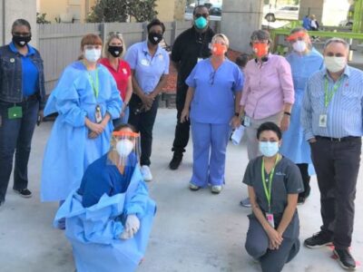Group of people in scrubs, masks, and PPE